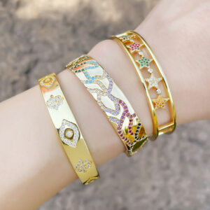 Gold-tone geometric wide cuff bracelet with inlaid stone details - Main product view