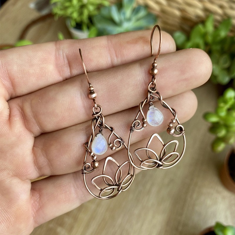 Retro gold-color lotus flower teardrop earrings with moonstone detail - Main product view