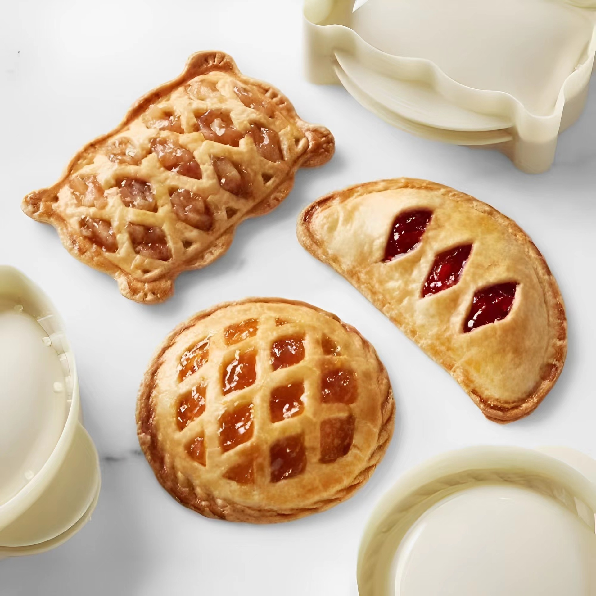 White plastic mini hand pie molds in round, semi-circle, and rectangular shapes - Main product view