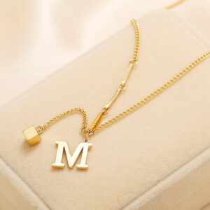 M-shaped geometric pendant necklace in 18K gold-tone titanium steel - Main product view
