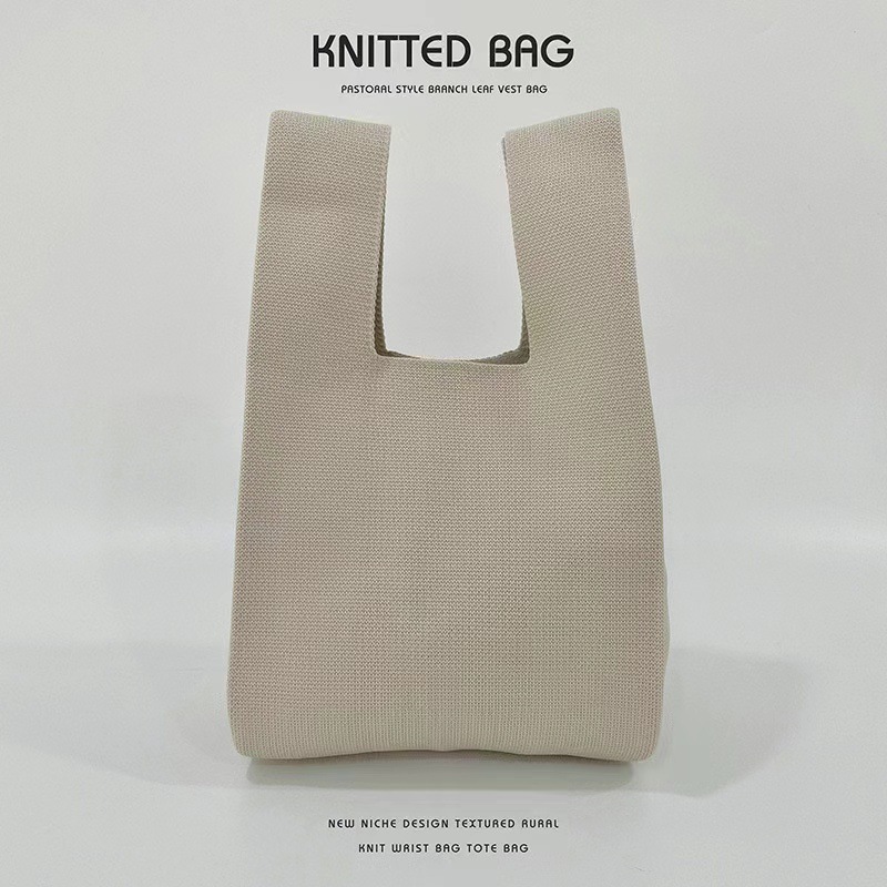 Women's knitted yarn tote bag in beige or black with open outer pocket - Main product view