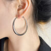 Large circle statement earrings in gold and silver color options - Main product view