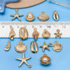 Gold-tone marine life charms including starfish and shell pendants - Main product view